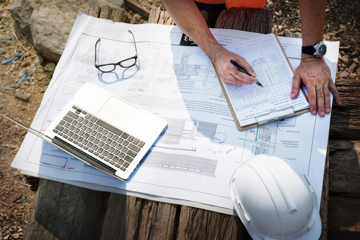 Construction professionals reviewing project drawings and checklists while selecting construction software for Indian project teams.