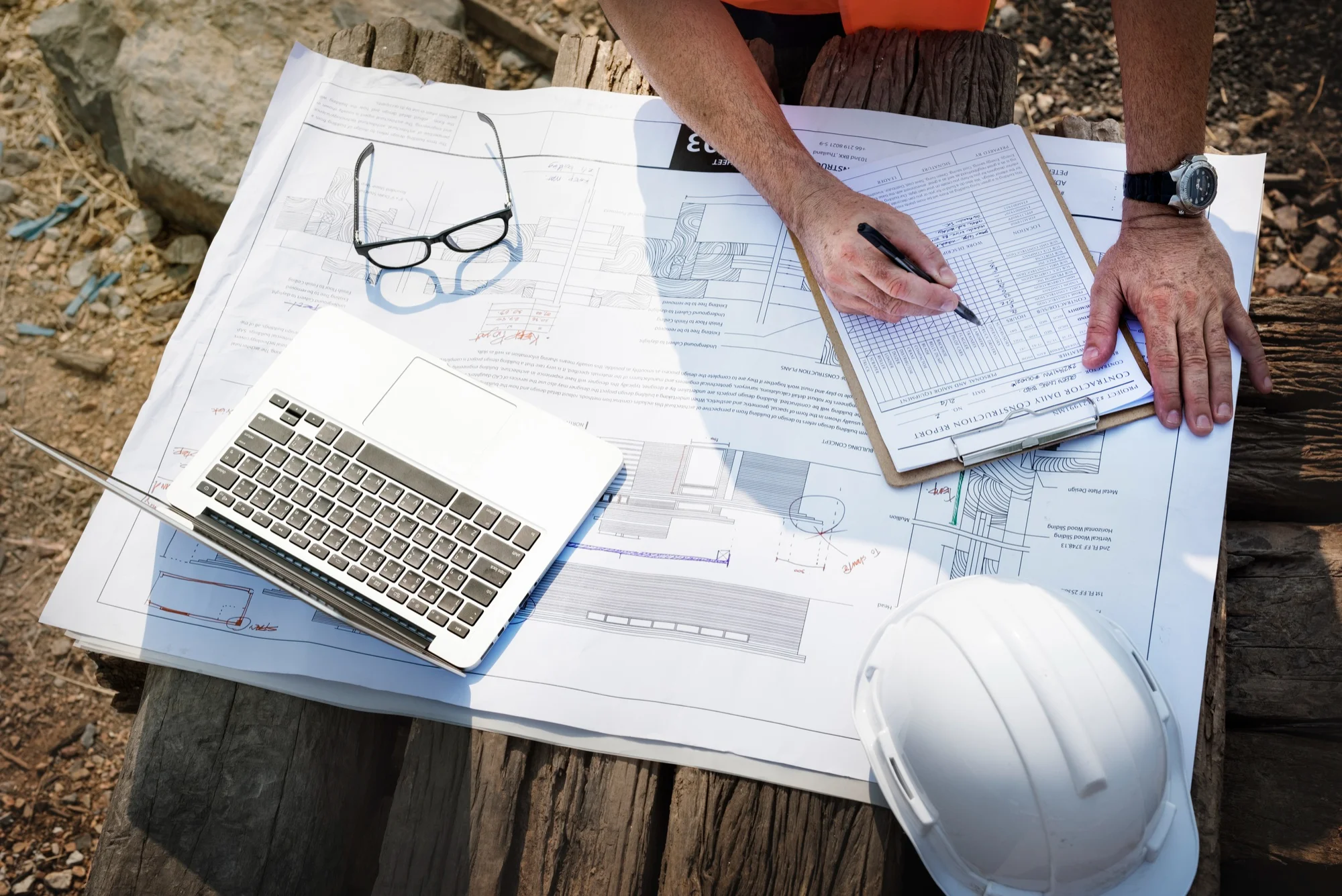 Construction professionals reviewing project drawings and checklists while selecting construction software for Indian project teams.