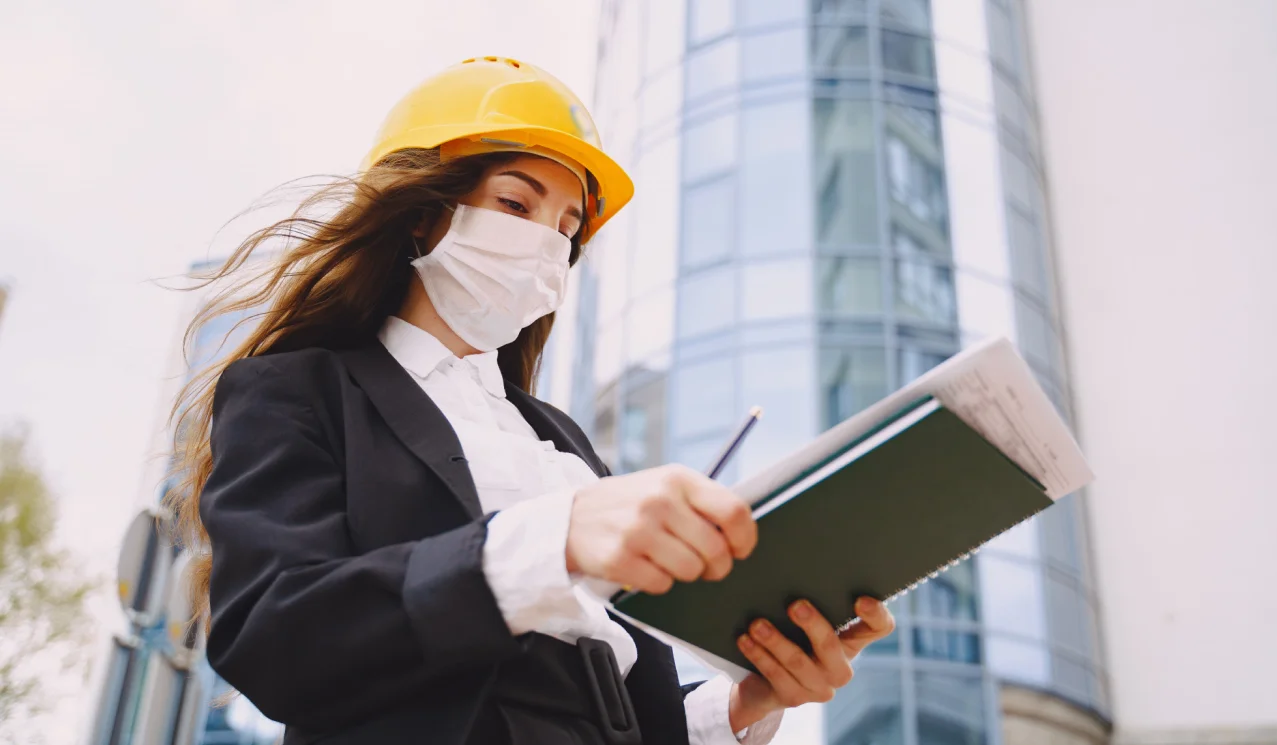 Engineer verifying construction document control and drawing approval workflow on site