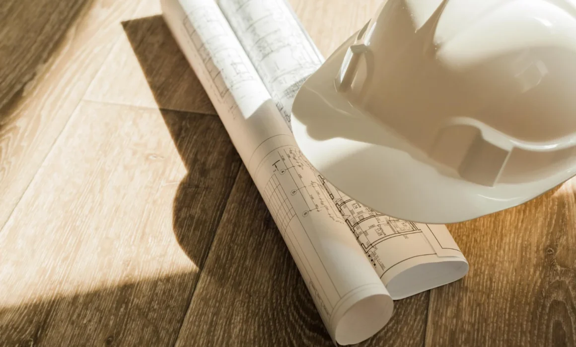 Construction drawings and hard hat at the end of a working day on site