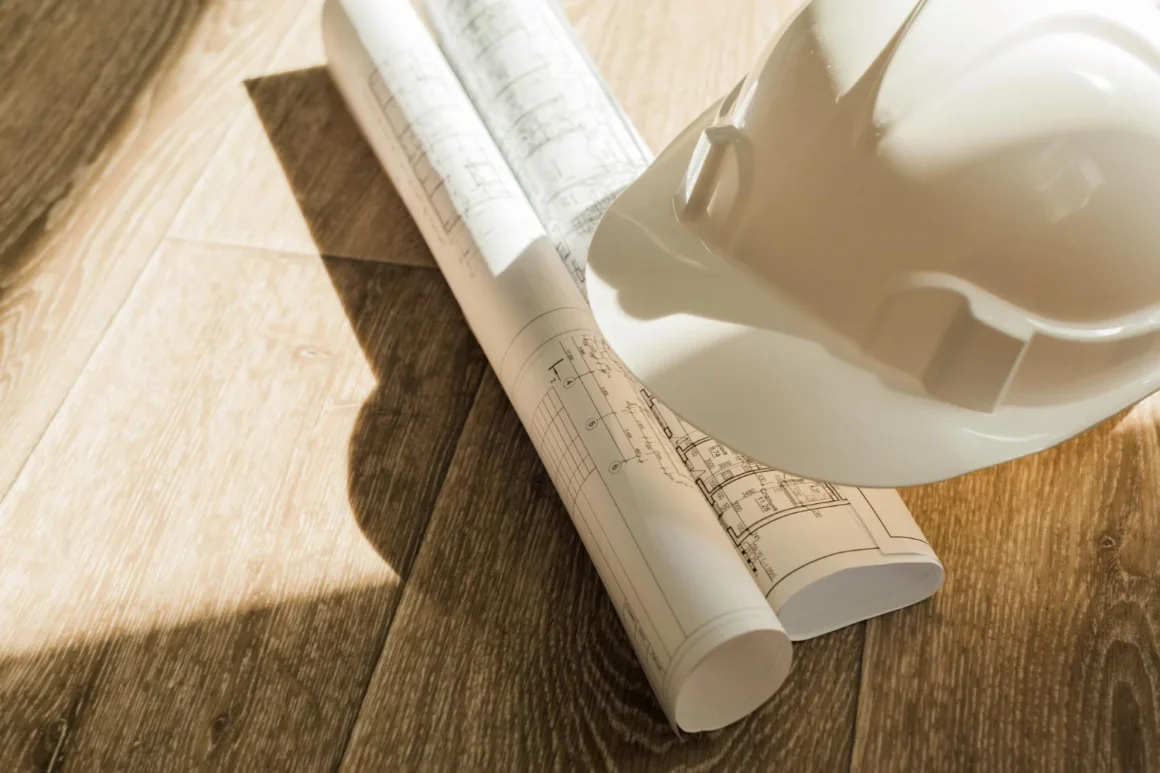 Construction drawings and hard hat at the end of a working day on site