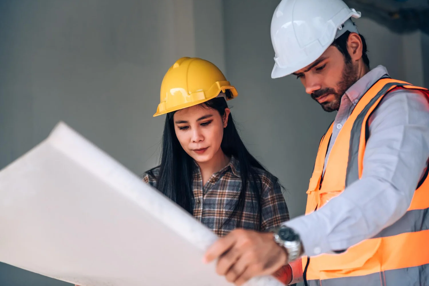 Site engineer tracking an RFI in construction on a tablet at a project site