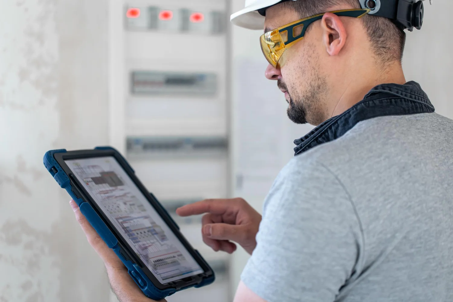 Engineer reviewing DPR entries and daily site records on a tablet