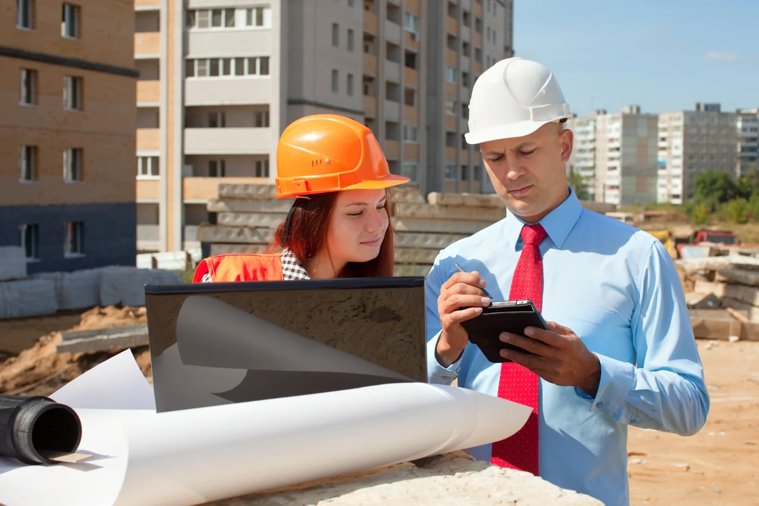 Site engineer and project manager recording the day's work progress on site